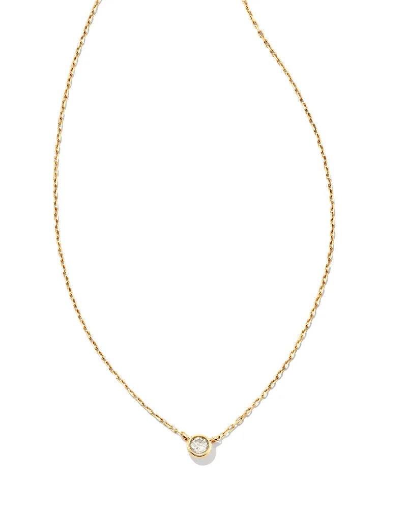 A gold chain necklace with a small charm